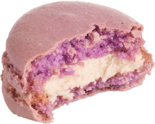 A pink macaron with a bite taken out, revealing a white filling.